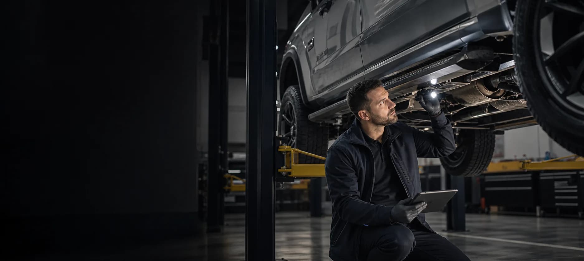 Professional conducting a detailed vehicle undercarriage inspection